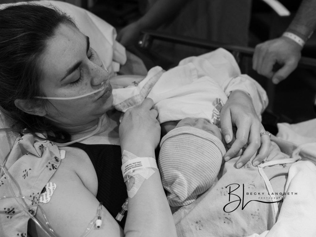 This image, an example of overcoming honest misconceptions about birth photography, shows a mother holding her baby after undergoing a c-section birth at EvergreenHealth Maternity Center in Kirkland, WA. This image was taken by Seattle birth photographer, Becky Langseth.