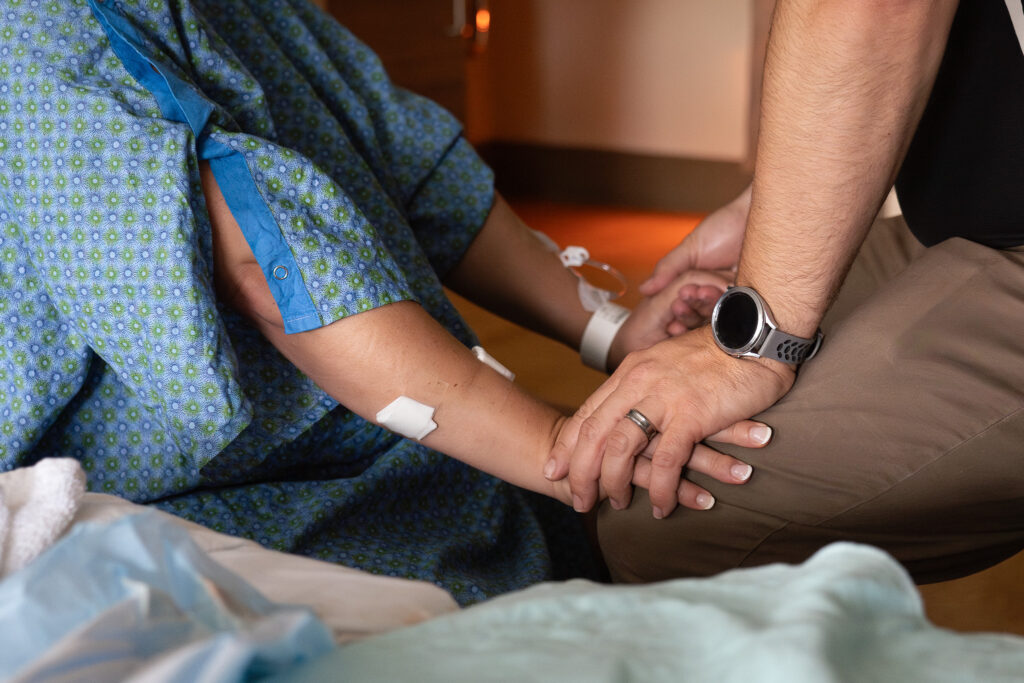 A couple holds hands as the pregnant mother labors at a hospital in Seattle.