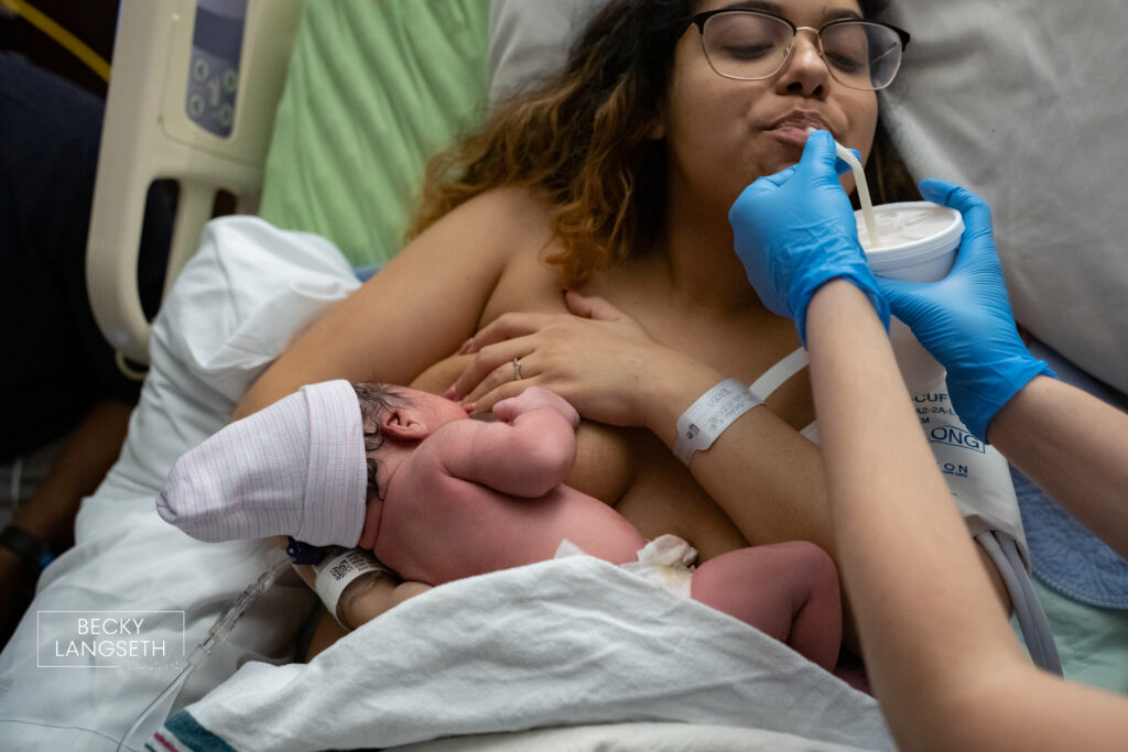 A new mother takes a sip of water as her newborn breastfeeds in the Family Birth Center at St. Michael Medical Center - Silverdale.