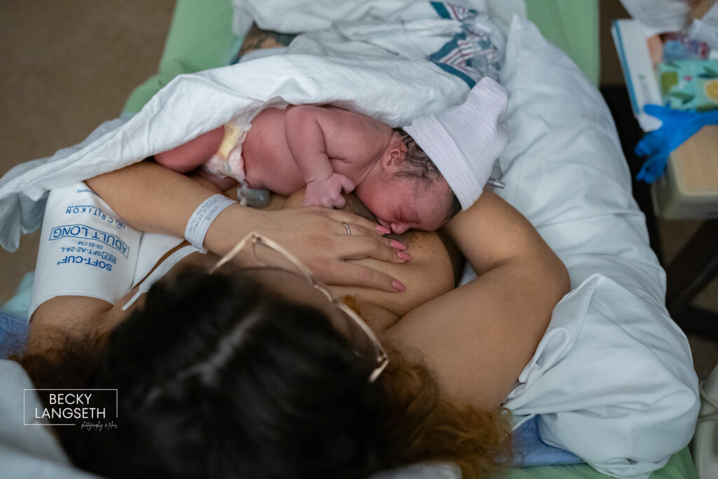 A mother breastfeeds her infant in her hospital bed at St. Michael's Medical Center in Silverdale, WA.