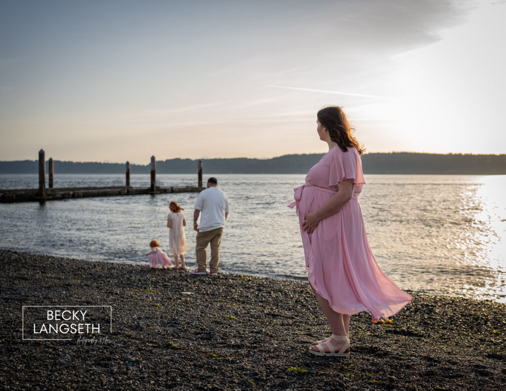 Family of four playing at Mukilteo Lighthouse Park near the dock. 