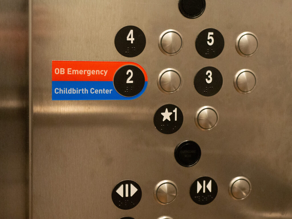 Inside the elevator at Overlake Medical Center with elevator buttons saying "childbirth center" and "OB emergency"