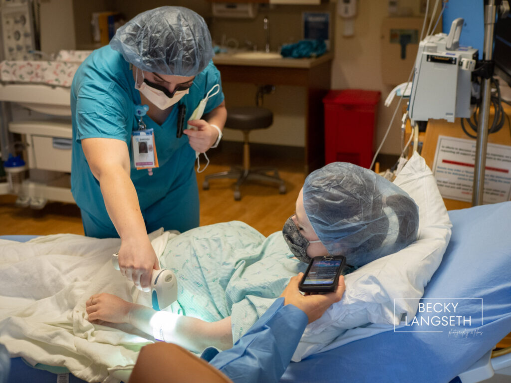 A nurse preps a pregnant patient before heading into the OR for a c-section birth at Swedish Issaquah Hospital.