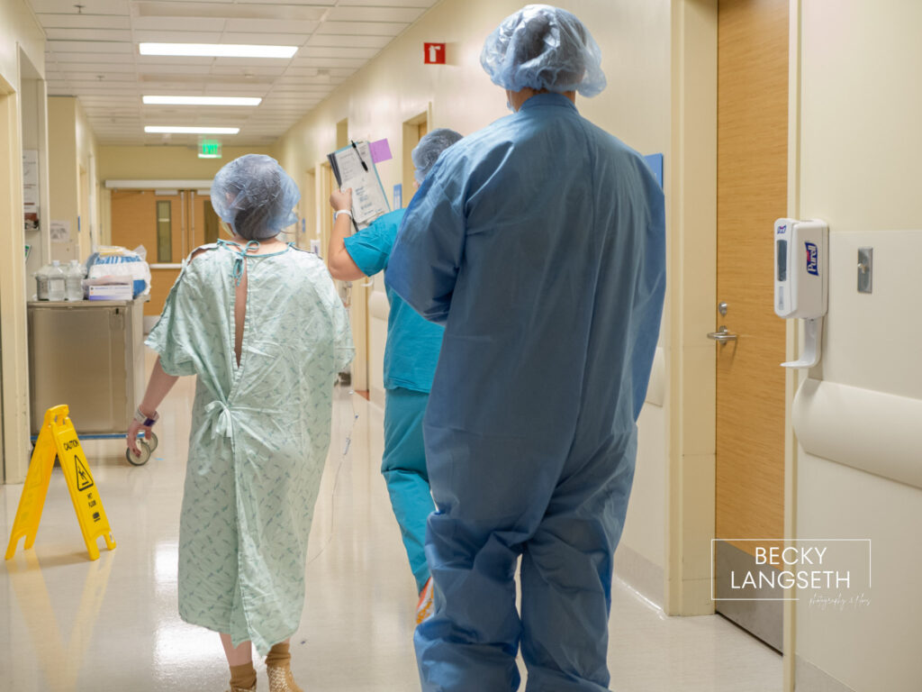 A pregnant woman is walking down the hospital hall on her way to the OR for a planned cesarian birth at Swedish Issaquah Hospital in Issaquah, WA.