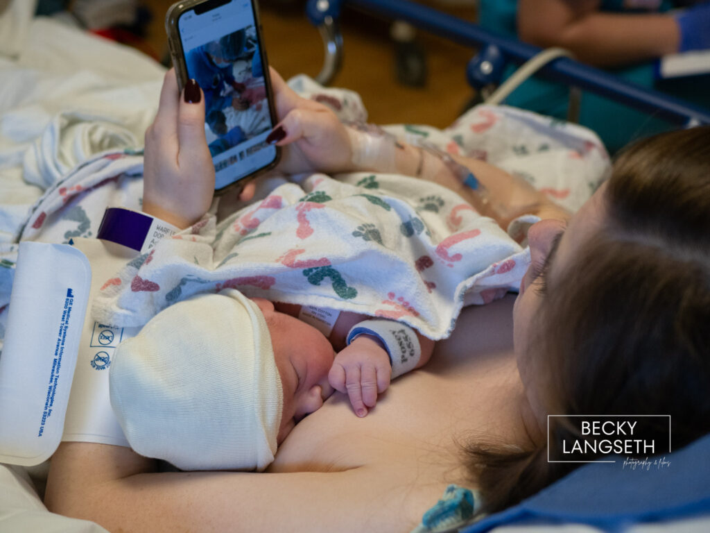 A new mother is watching a video on her phone of what happened in the OR where she had a cesarian birth at Swedish Hospital in Issaquah, WA.