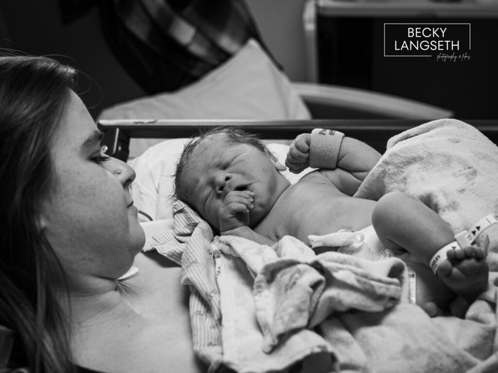 A black and white image of a new mother holding her baby for the first time after a cesarian birth at Swedish Issaquah Birth Center in Issaquah, WA.