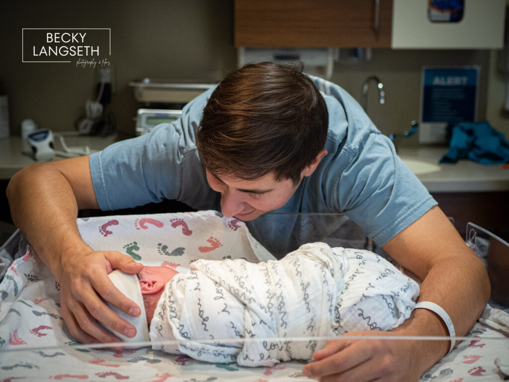 A new dad looking has his newly born infant in the baby warmer at Swedish Issaquah Birth Center in Issaquah, WA. 