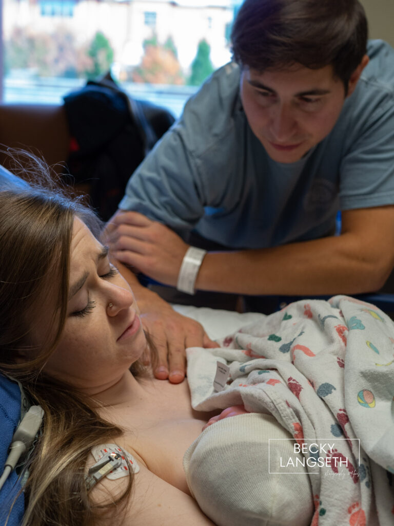 A mother emotionally looks at her baby while doing skin-to-skin after a c-section birth at Swedish Issaquah Hospital in Washington State.