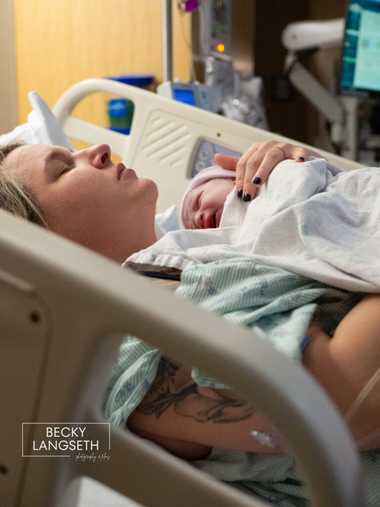 A new mother holds her baby doing skin-to-skin during the golden hour after giving birth at Overlake Childbirth Center in Bellevue, WA.