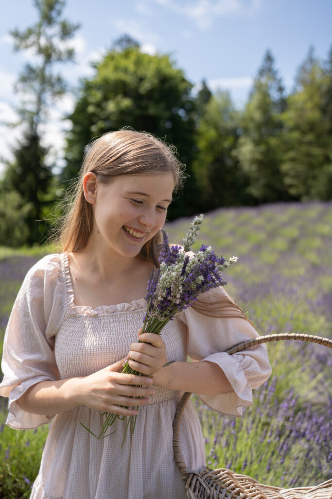 a girl in a light dress holding a bouquet of lavender at Arlington Lavender Farm