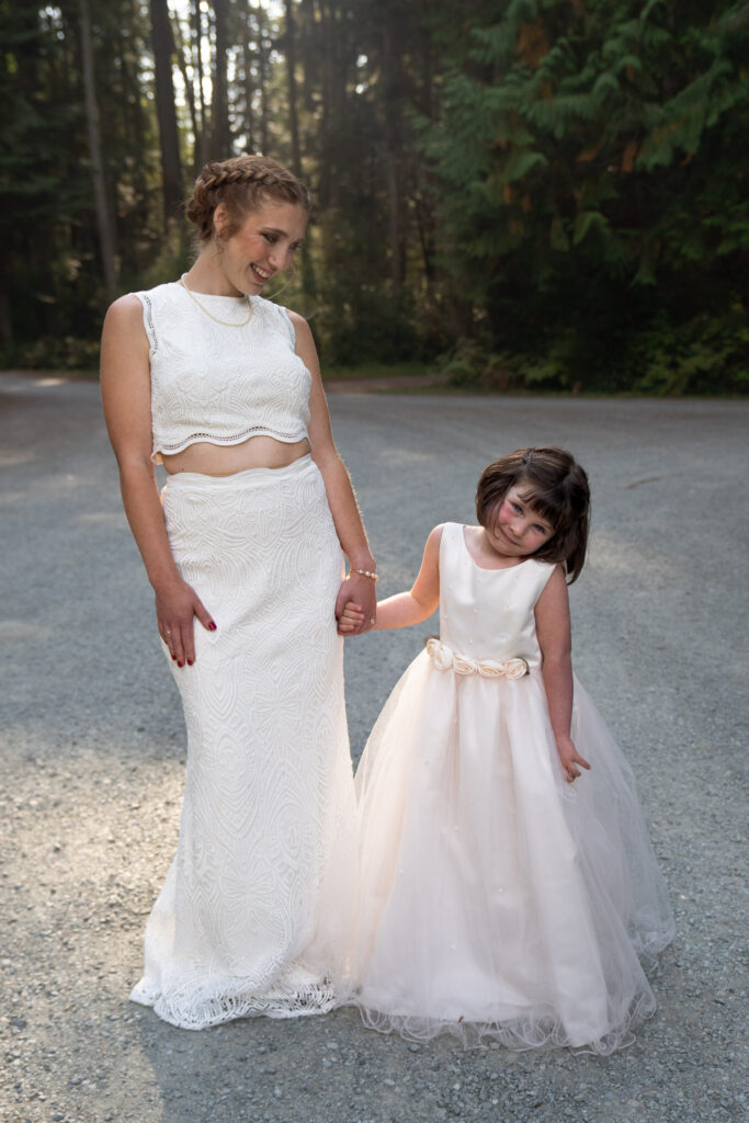 bride holds had with her daughter dressed up as their flower girl.