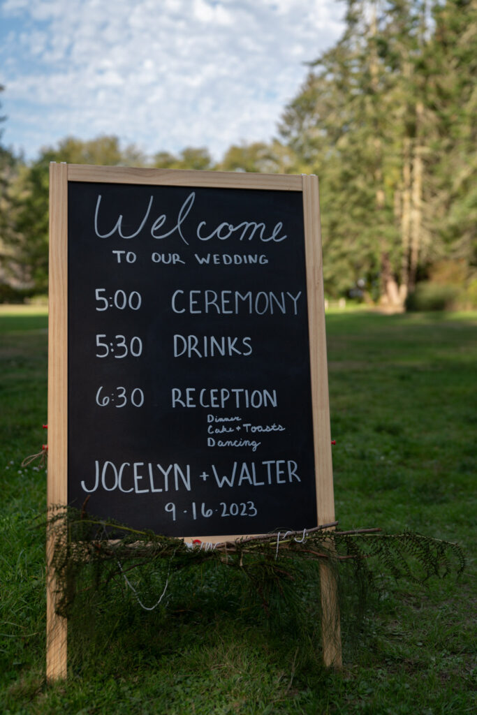 A sandwich sign of the schedule for the wedding events.