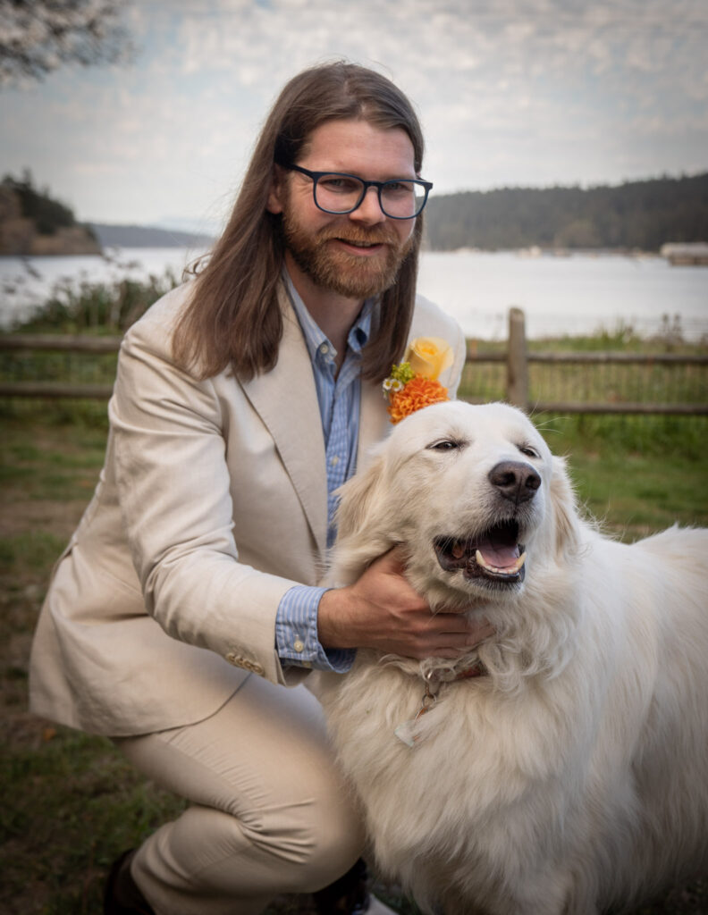 groom poses with his dog before his wedding at Deception Pass