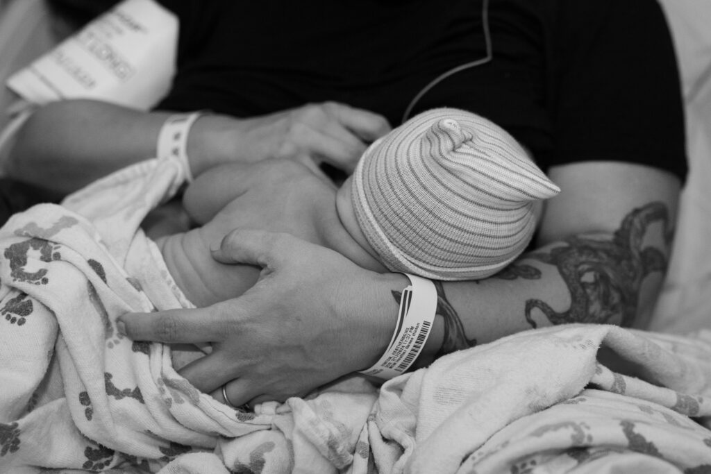 Close up of baby and mom's hands as she breastfeeds