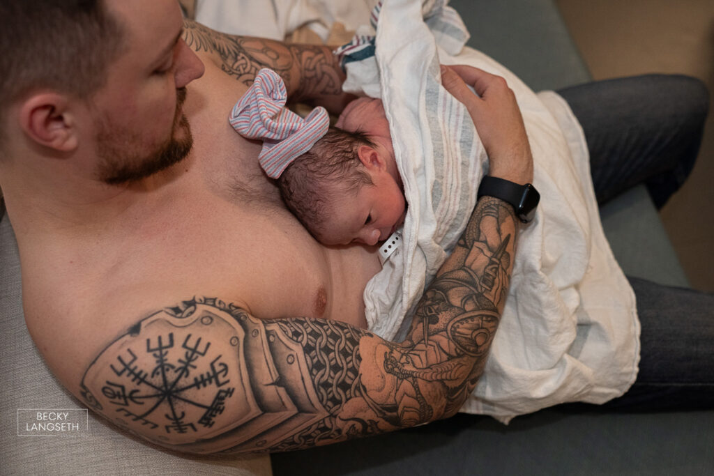 a new dad holds his new baby skin-to-skin at Evergreen Hospital in Kirkland, WA