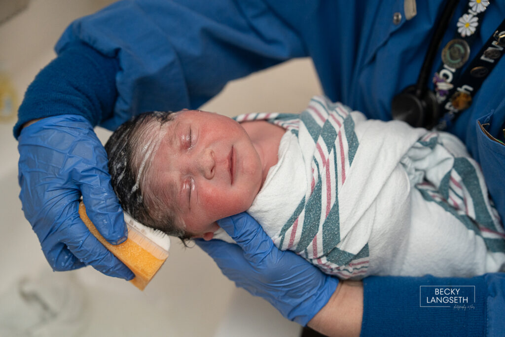 nurse washing baby's hair at the hospital