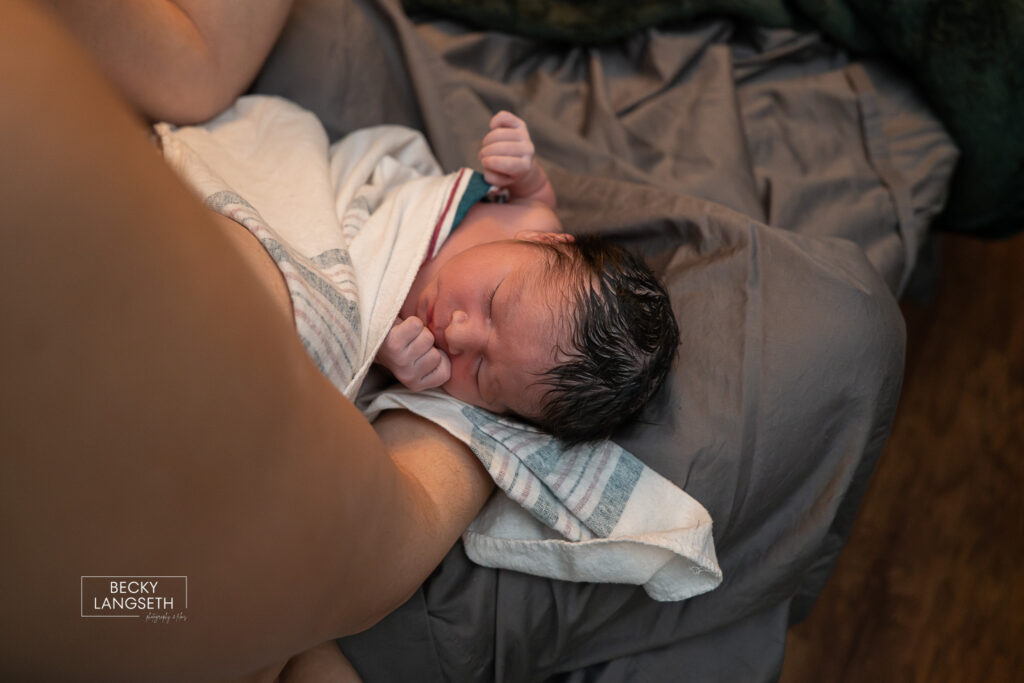 up close image of baby in mom's arms