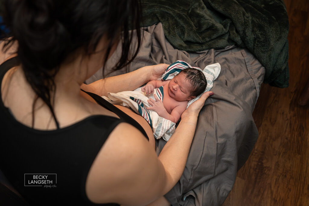 another angle of mother holding her baby born at home in Sammamish