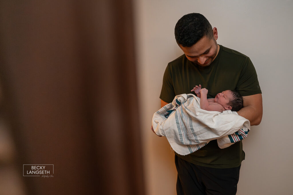 dad holding baby at a homebirth
