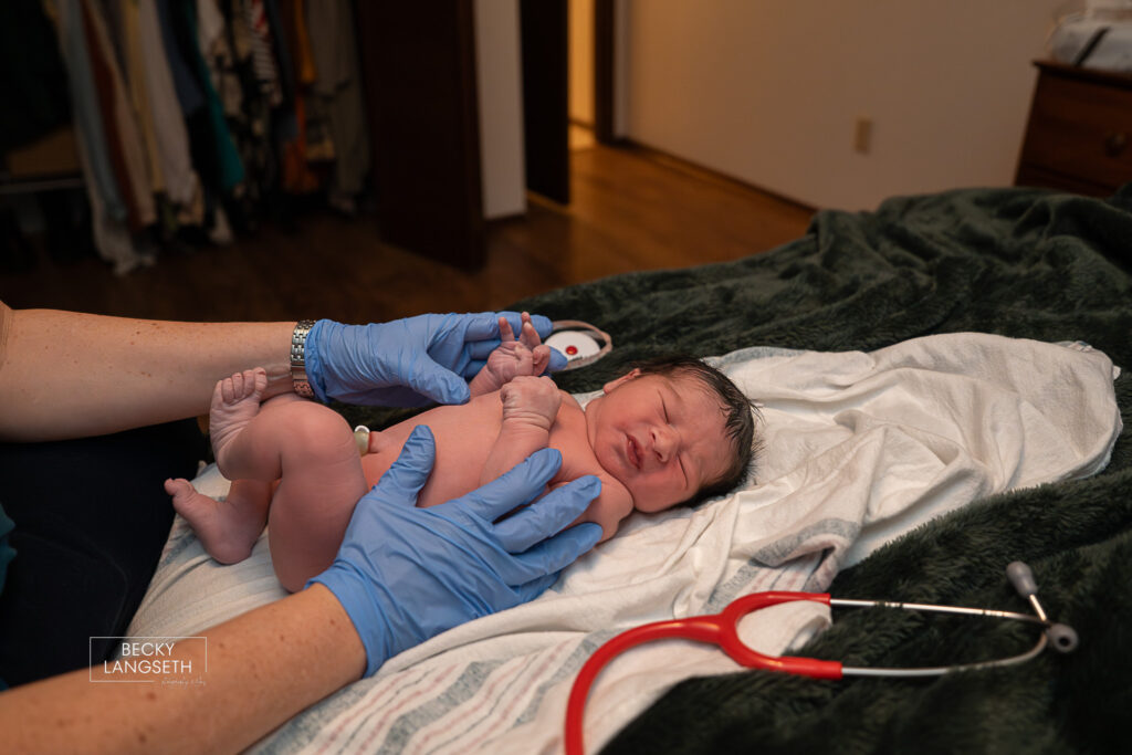 midwife doing a newborn exam at a homebirth in Sammamish