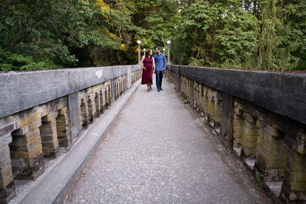 couple walking together across a stone bridge