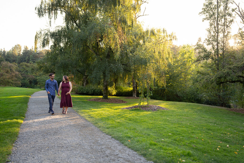 A couple walking along a gravel path at Washington Park Arboretum in Seattle